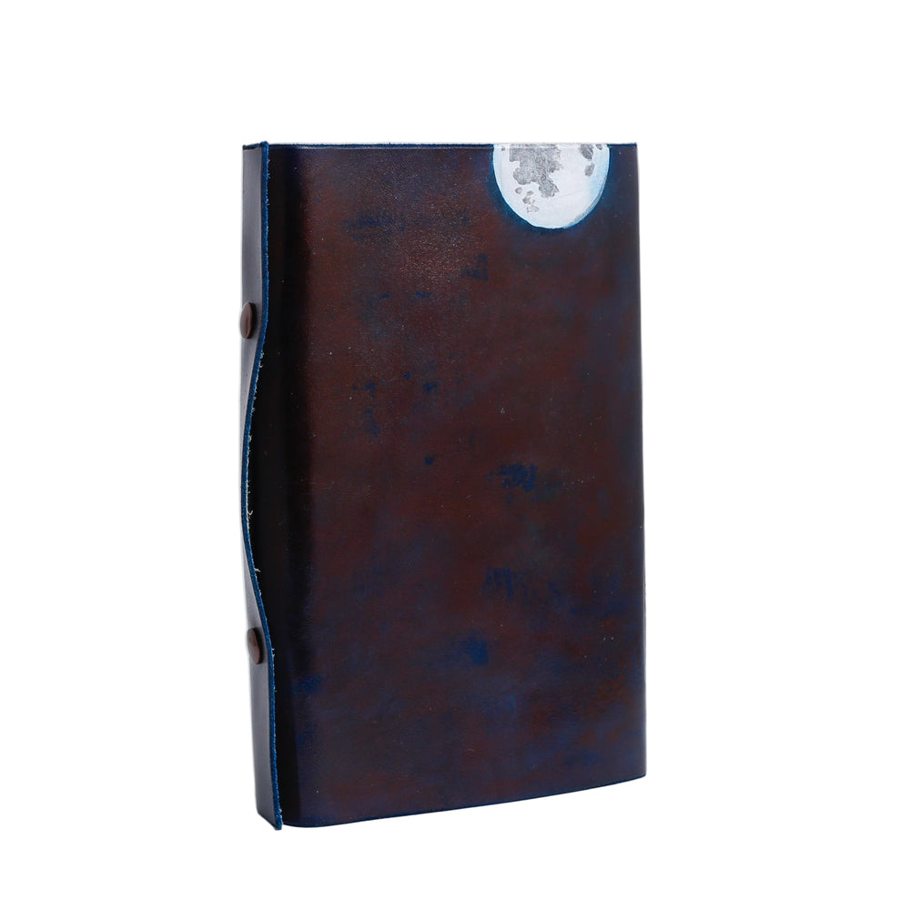 Dark brown leather journal with a tree and moon.