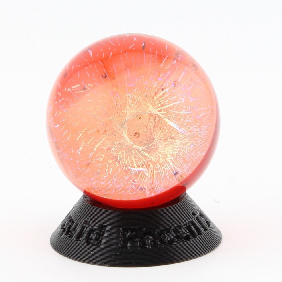 #9 Rainbow Dichroic Chaos Glass Marble on Pomegranate Red