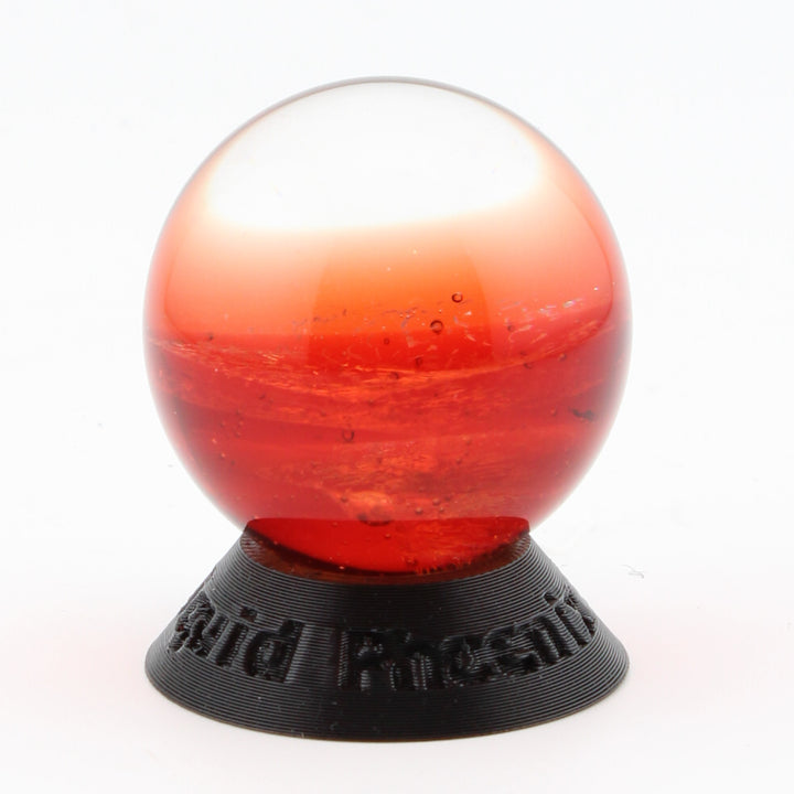 #9 Rainbow Dichroic Chaos Glass Marble on Pomegranate Red