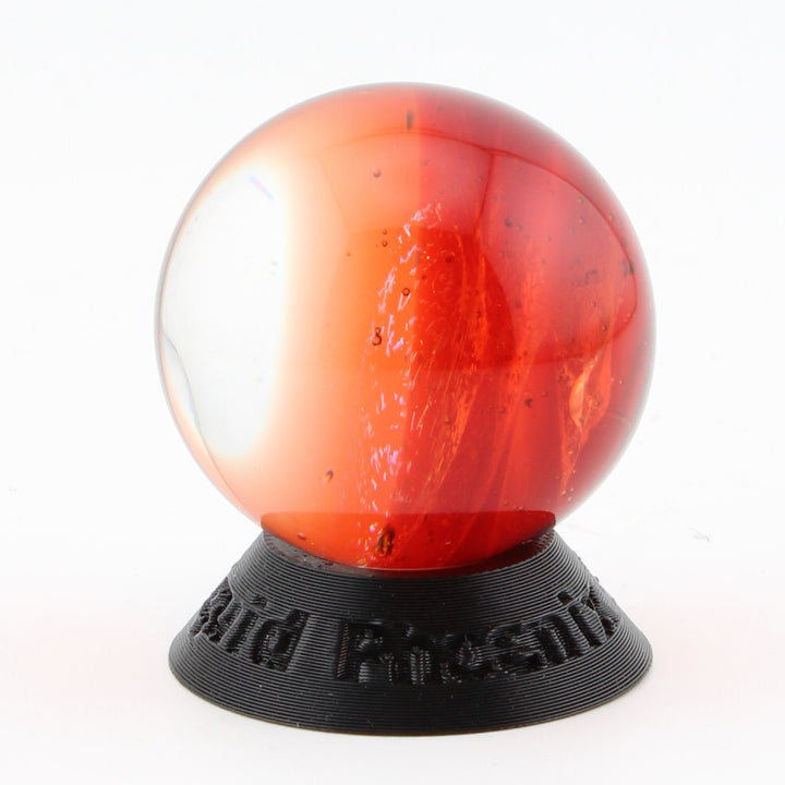 #9 Rainbow Dichroic Chaos Glass Marble on Pomegranate Red