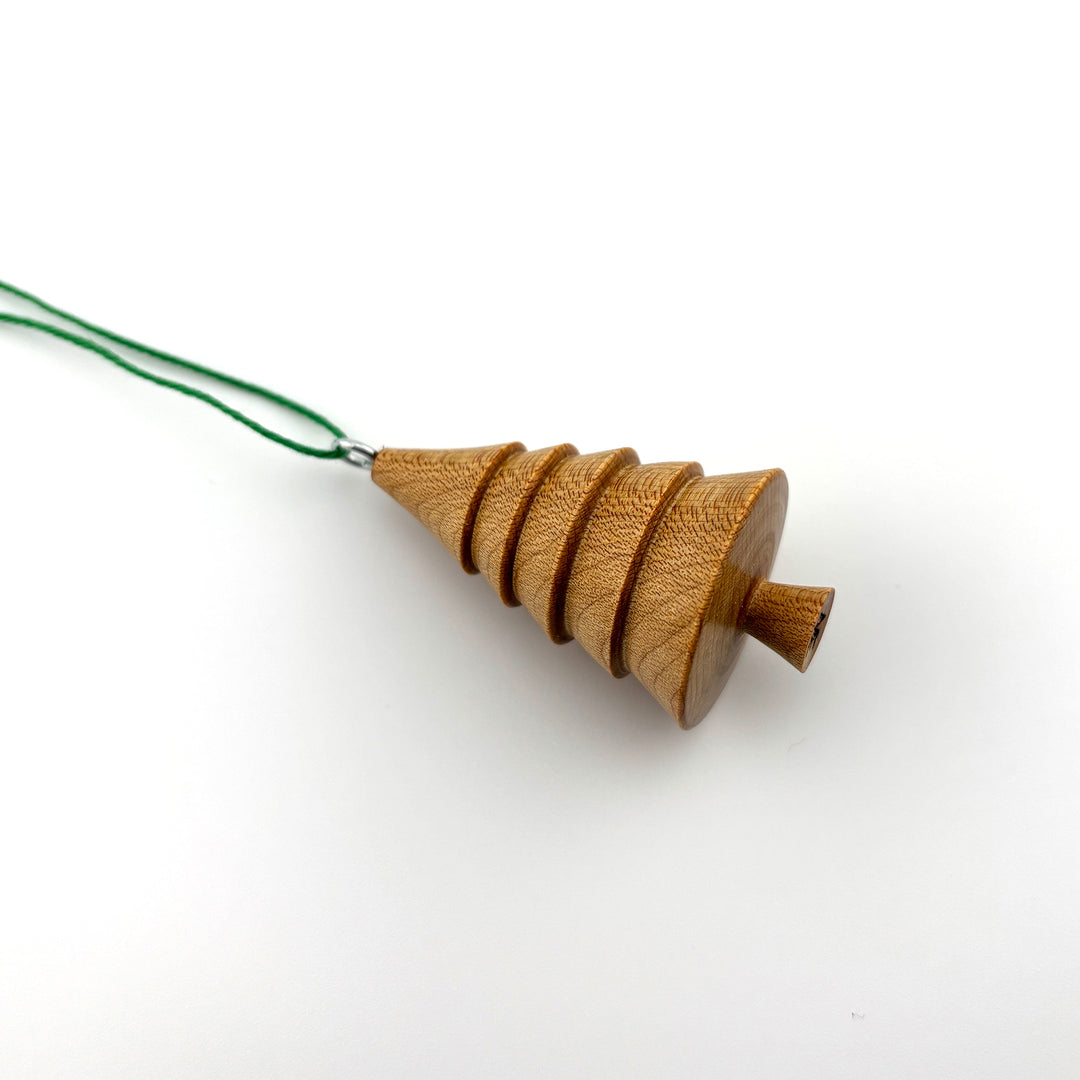 hand turned wooden ornament shaped like a tree.